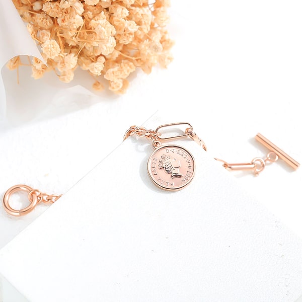 Rose gold coin and dual chain bracelet close up details