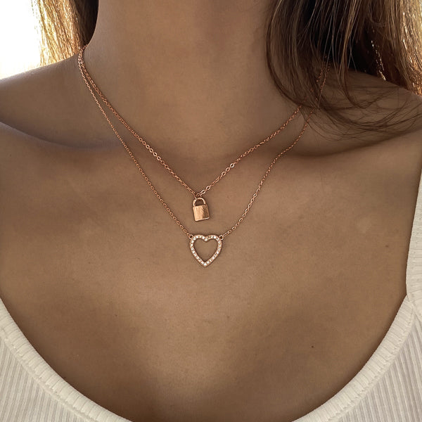 Woman wearing a rose gold crystal open heart necklace