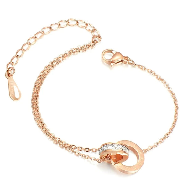 Rose gold anklet with two interlocked rings - one with roman numerals and one with crystals