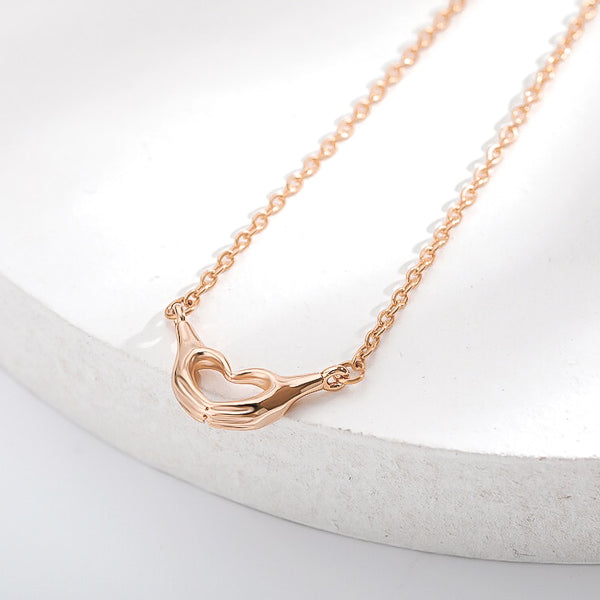 Rose gold heart hand sign necklace display