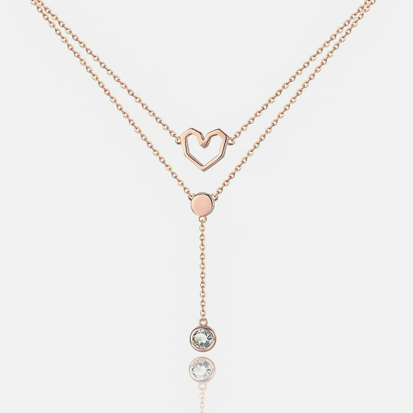 Details of the rose gold layered heart necklace with a crystal drop chain