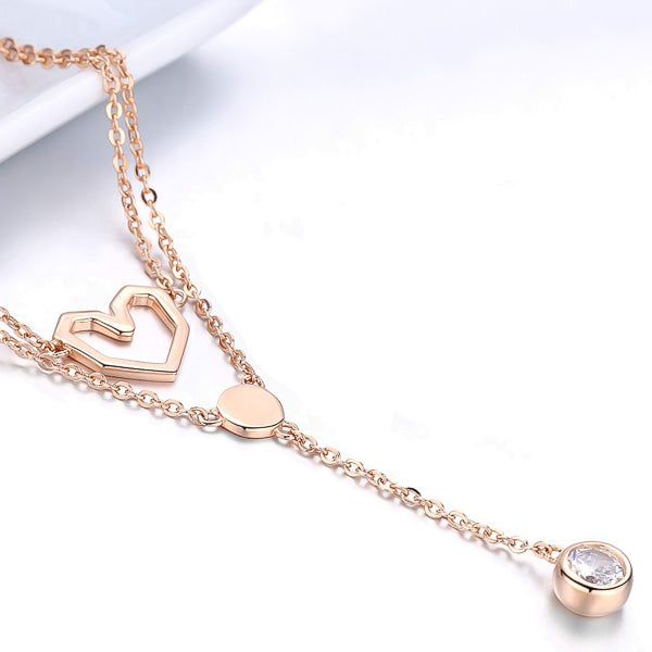 Rose gold layered heart necklace with a crystal drop chain display