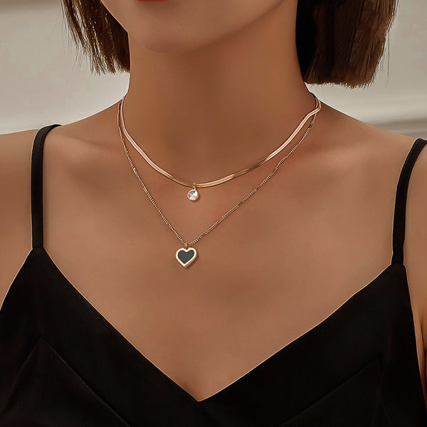 Woman wearing a rose gold layered heart crystal pendant necklace