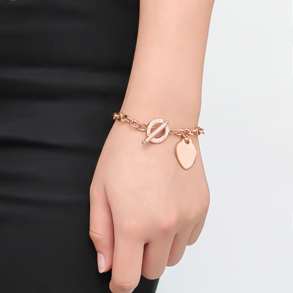 Rose gold love heart chain bracelet on a woman's wrist