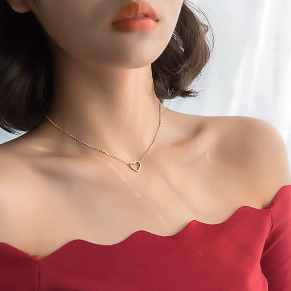 Woman wearing a rose gold open heart choker necklace