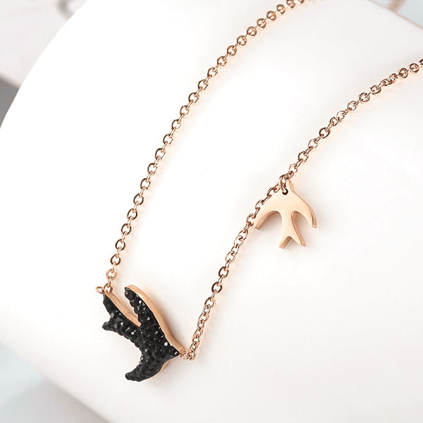Rose gold swallow necklace display