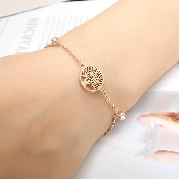 Rose gold tree of life chain bracelet on a woman's wrist
