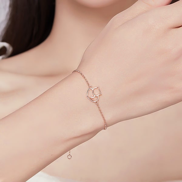 Rose gold vermeil cat bracelet on a woman's wrist