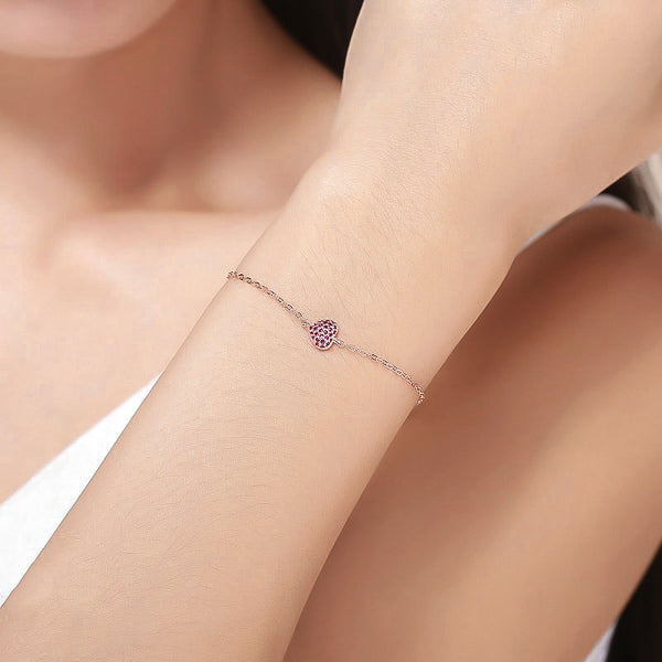 Rose gold love heart bracelet on woman's wrist