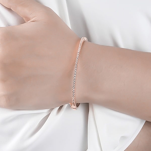 Rose gold zirconia bangle bracelet on a woman's wrist