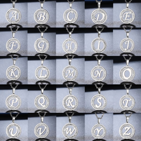 Round silver coin pendant with cursive initial letter and sparkling crystal halo