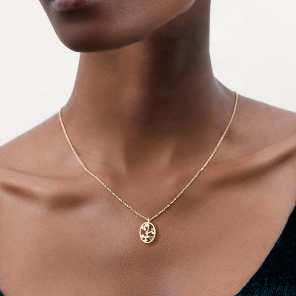 Woman wearing Sagittarius constellation necklace