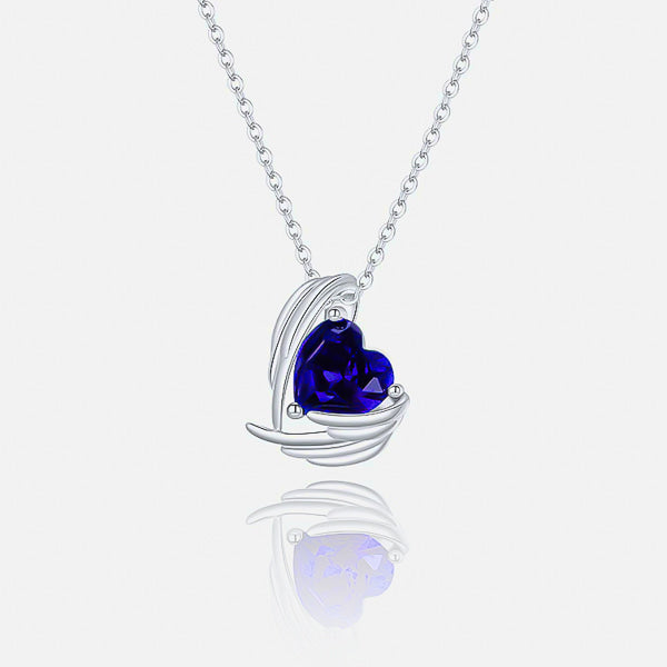 Sapphire blue crystal heart and angel wings pendant on a silver chain details