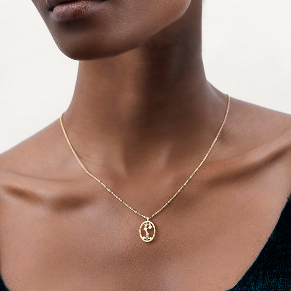 Woman wearing Scorpio constellation necklace