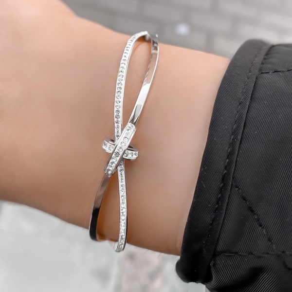 Woman wearing a silver crystal knot bracelet
