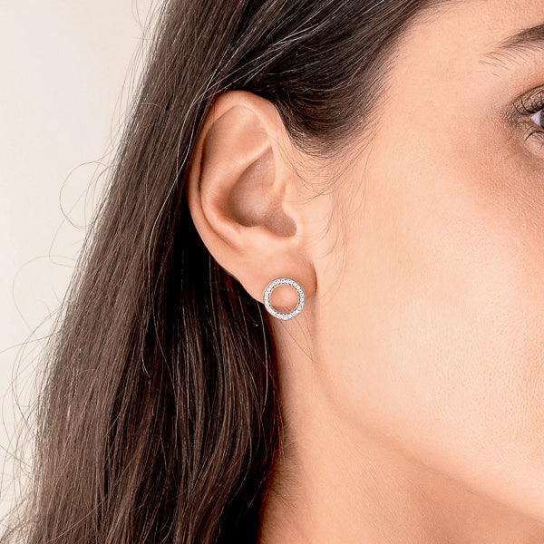 Woman wearing silver circle stud earrings
