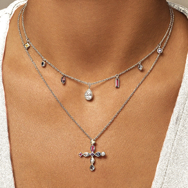 Woman wearing a silver Greek crystal cross necklace