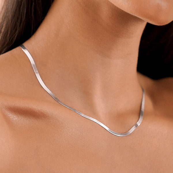 Woman wearing a 3mm silver herringbone chain necklace