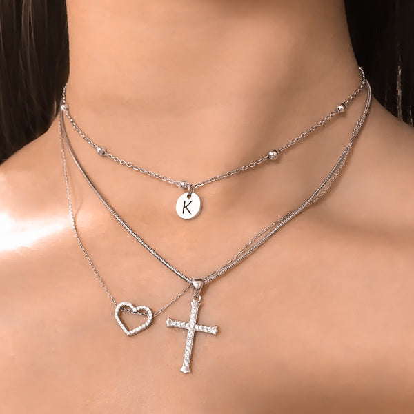Woman wearing a beaded silver initial disc choker necklace