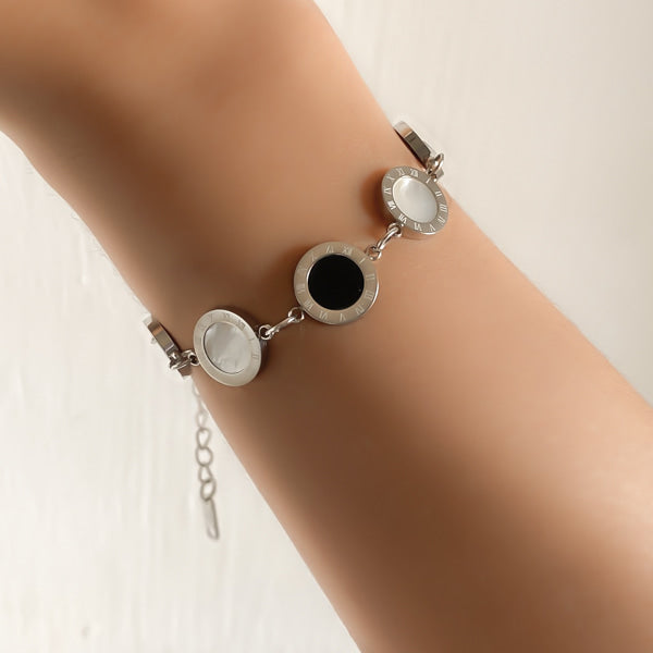 Woman wearing a silver Roman numeral bracelet