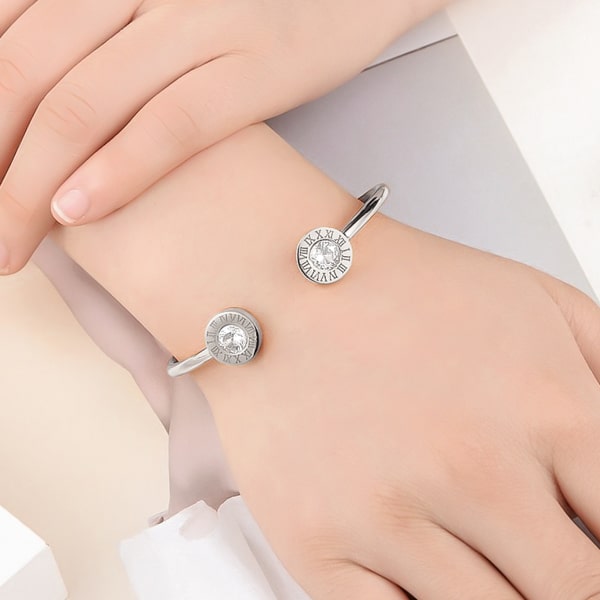 Woman wearing a silver Roman numeral cuff bracelet