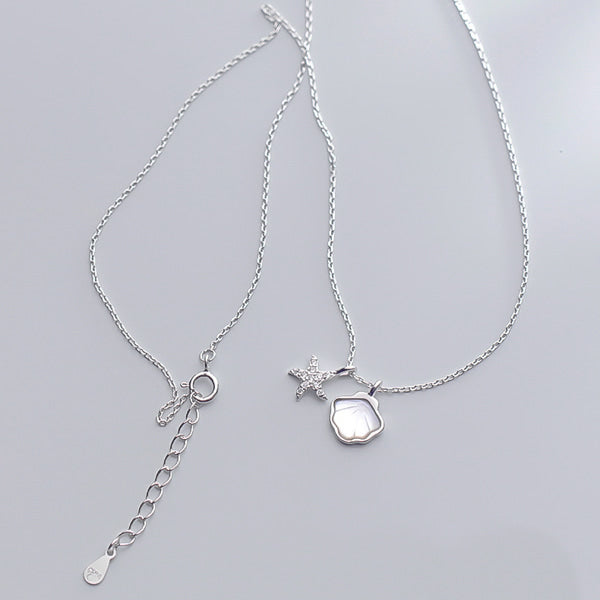 Silver starfish and seashell necklace details