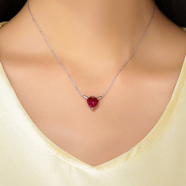 Woman wearing a red crystal angel heart on a silver necklace