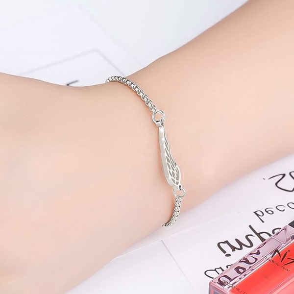 Silver angel wing bracelet on a woman's wrist