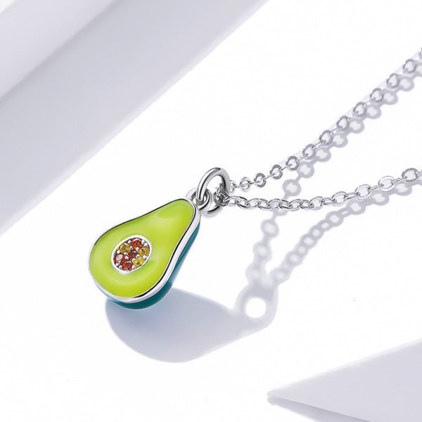 Green avocado fruit pendant on a silver necklace side profile close up