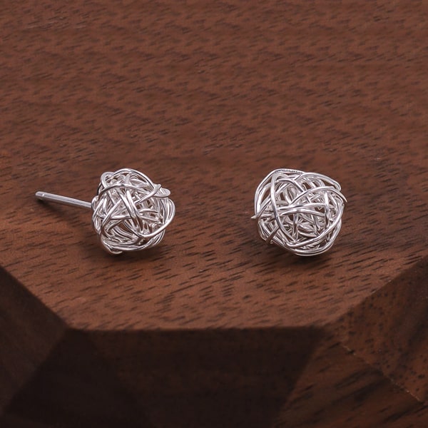 Silver ball of wool stud earrings detail