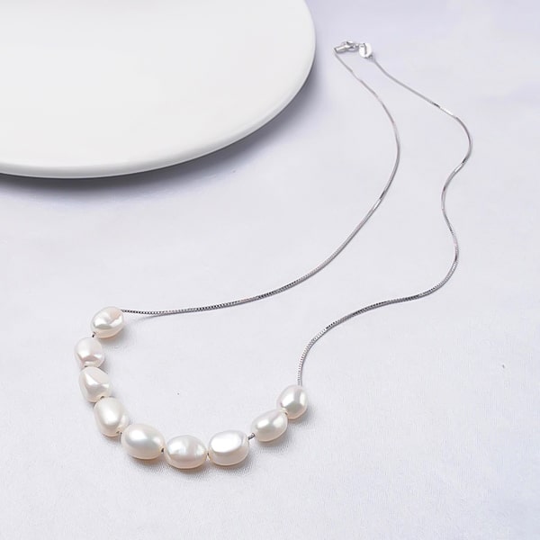 6-7mm white baroque freshwater pearls on a silver necklace