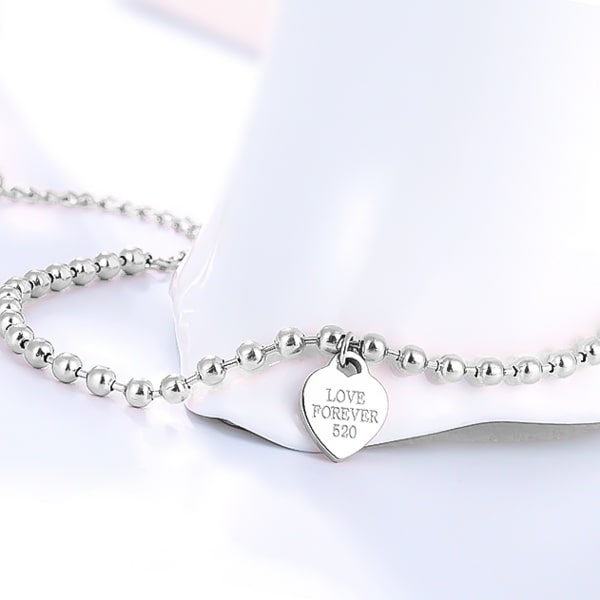 Silver beaded heart charm ankle bracelet detailed close-up