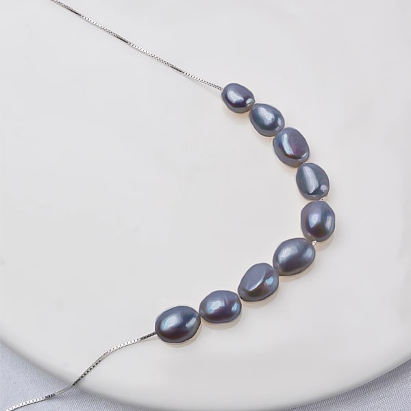 6-7mm black baroque freshwater pearls on a silver necklace close up