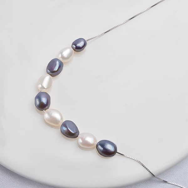 6-7mm black and white baroque freshwater pearls on a necklace close up