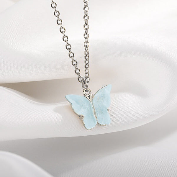 Blue butterfly pendant on a silver necklace display