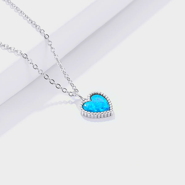 Silver necklace with a blue Opal heart pendant viewed from its side