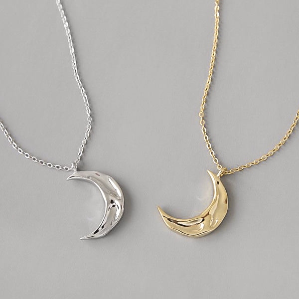 Silver crescent moon necklace display