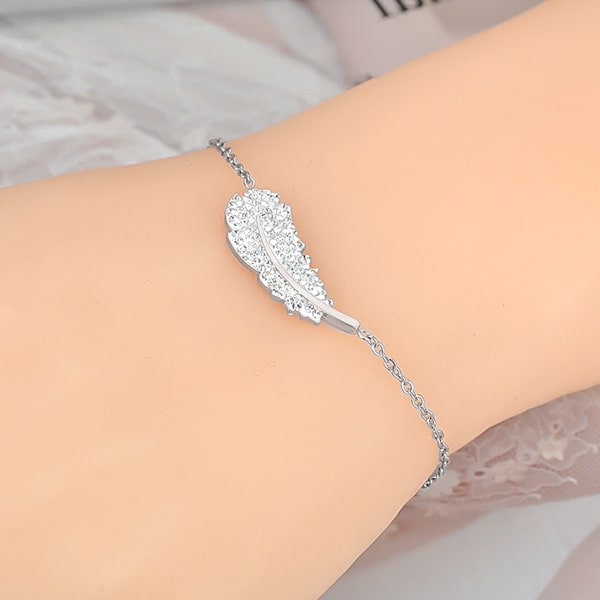 Silver crystal feather bracelet displayed on a woman's wrist