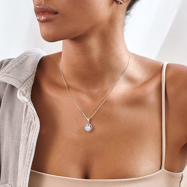 Woman wearing a silver crystal halo pendant necklace