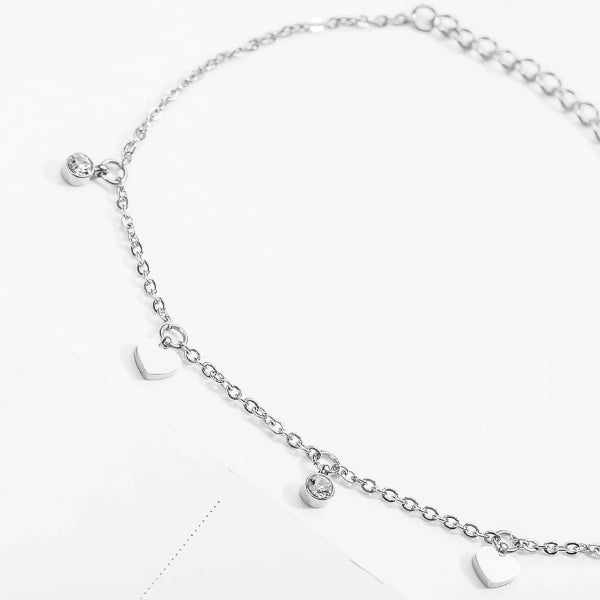 Silver love charm anklet with heart and crystal pendants close up