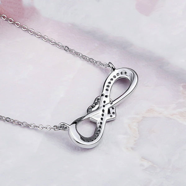 Backside of the silver infinity necklace with a heart knot and crystal trim