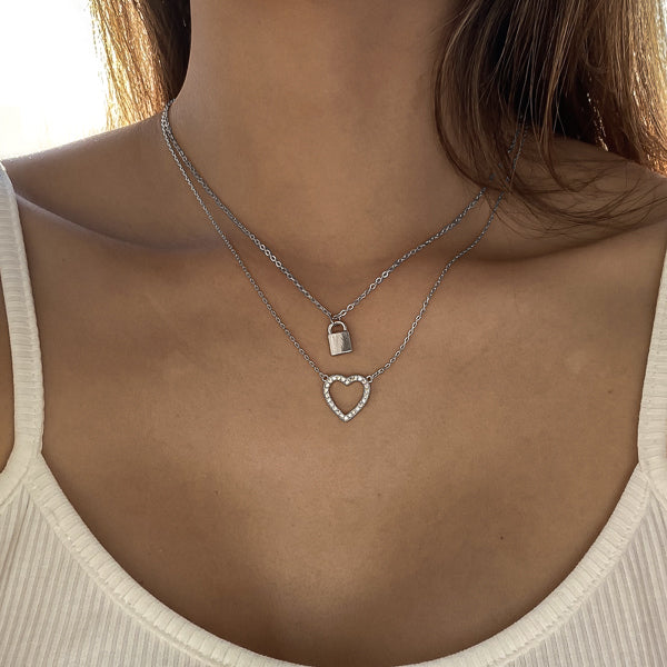 Woman wearing a silver crystal open heart necklace