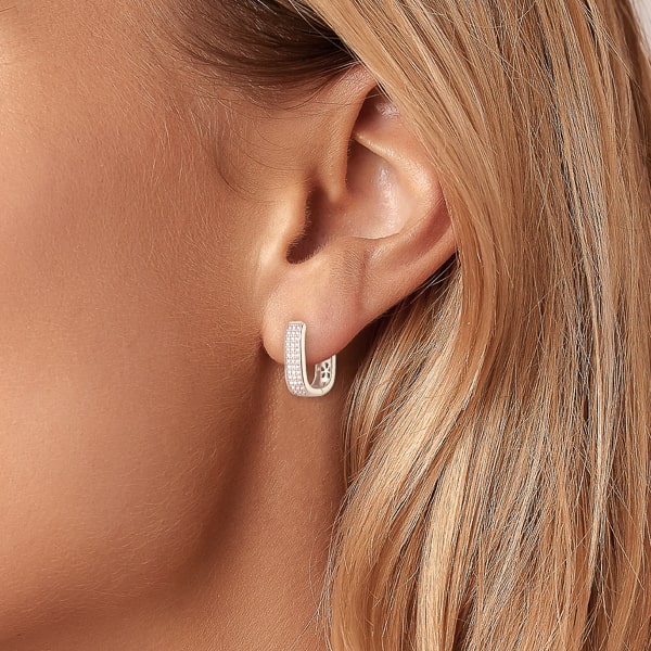 Silver crystal pavé oval hoop earrings on woman