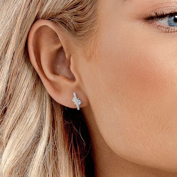 Woman wearing silver crystal podium stud earrings