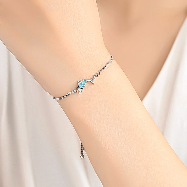 Silver dolphin bracelet on a woman's wrist