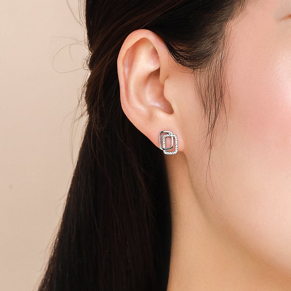 Woman wearing silver double square stud earrings
