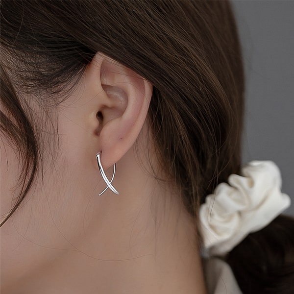 Woman wearing silver eternal love earrings