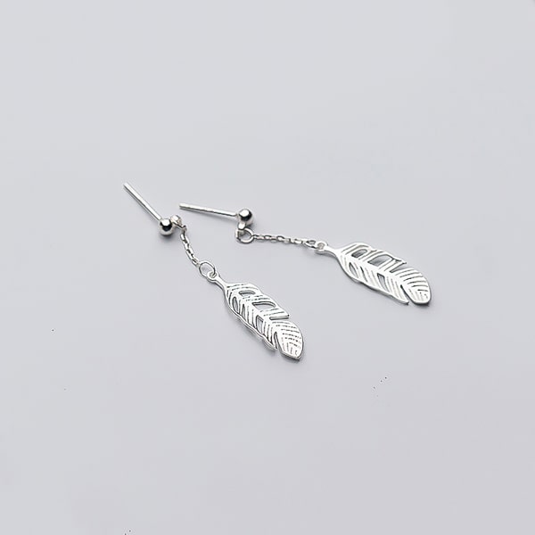 Silver feather drop earrings detail