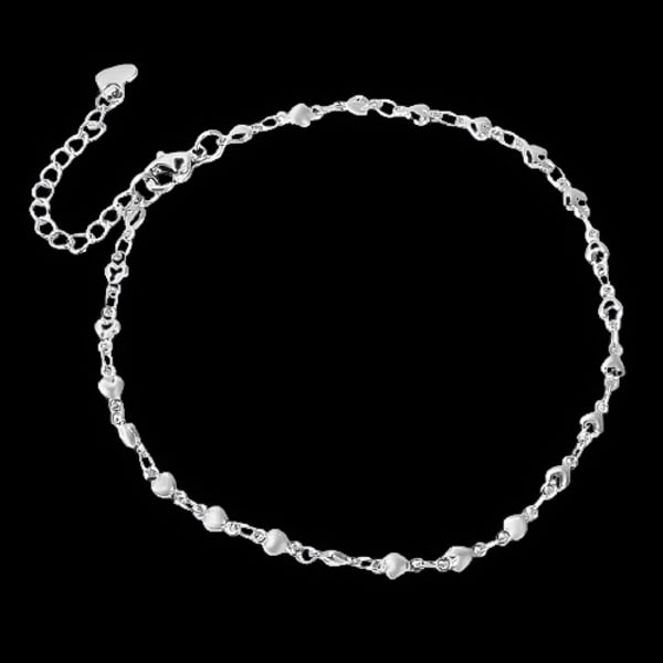 Silver heart chain anklet on a dark background