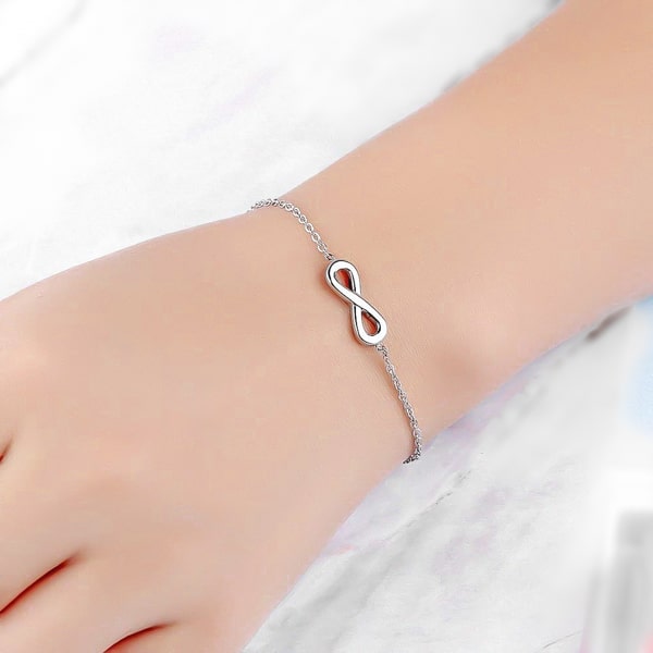 Silver infinity bracelet on a woman's wrist